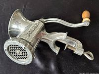 Photo of the side angle showing the cast metal body with 'PORKERT' embossed on it and the handle with wooden knob.