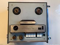 Top view of Concord Transistorized Stereophonic 550 reel to reel tape recorder showing the tape reels, push button controls, VU meters, knobs, and power button.