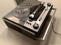 Angled front view showing transport controls, side speakers and carrying handle