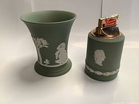 Photo showing the green jasperware holder and matching lighter side by side with classical white relief figures.
