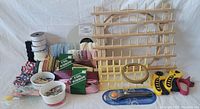 Full display of sewing supplies including ribbon holders, ribbons, pins, rotary cutters, scissors, and embroidery hoop