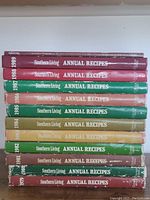 Stack of 11 Southern Living Annual Recipes cookbooks arranged by year, 1979 to 1989, showing covers and spines with some wear.