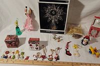 Photo showing full variety of ornaments, ribbons, and tree topper in lot