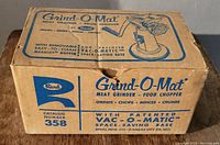 Original box for Rival Grind-O-Mat meat grinder, labeled with model number 358 and features such as Vac-O-Matic base.
