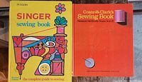 Front covers of two sewing books: the yellow Singer Sewing Book with retro imagery and the orange Coats & Clark's Sewing Book featuring a needle and thread graphic.