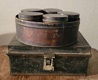 Close-up image of the circular metal spice container showing five spice jars placed inside on top of the rectangular metal box.