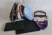 Group shot of the wallet, four makeup bags, and two headbands showing overall lot contents and varying patterns and colors.