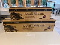 Two boxed RTA Traditional Wooden Wine Racks, stacked, labeled 15 and 42 bottle capacity