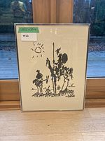 Frontal view of framed black and white abstract art resting against window