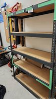 Front and side angled view of the 5-level shelving unit showing metal frame and wood shelves.
