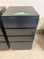 Front view of a black Muura Me 4-drawer storage unit showing clean flat drawer fronts and squared edges.