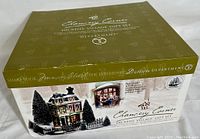 Packaging box showing label, brand, and image of illuminated building and included items.