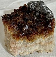 Natural citrine crystal cluster on quartz matrix with cast pewter buffalo figurine on top, showing the amber and golden tones of the crystals and the silver-toned buffalo detail.