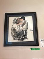 Framed Asian print showing elderly man embracing child, includes calligraphy and red circular stamp.