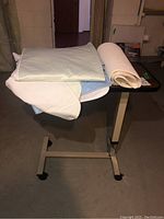 Bed table with pads and mats on top in basement setting