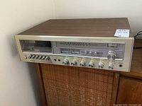 Front view of Centrex by Pioneer cassette AM/FM stereo compact system with wood grain top, showing control knobs, buttons, and tuner dial.