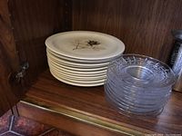 Stack of 12 Rosenthal porcelain dinner plates with continental silhouette rose design and stack of 13 clear cut glass luncheon plates