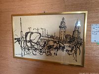 Framed signed artist print showing cityscape with horse-drawn carriage and buildings.