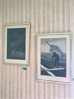 Two framed Japanese prints hanging side by side on wallpapered wall, showing overall lot
