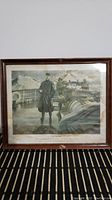Framed print showing the full artwork with a man standing on a ship's deck, framed with glass in a wooden frame.