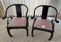 Front view of two Bernhardt Flair black onyx finished chairs with rose upholstered seats arranged side by side showcasing their style and condition.