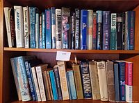 Four shelves of books mainly on historical and biography topics. Books include titles on WWII, warfare, biographies like Harry Truman, and indigenous history. Used condition with visible wear on some dust jackets.