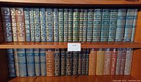 Two shelves of International Collectors Library hardcover books in various cloth bindings with gilt-stamped spines