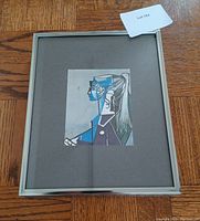 Framed Picasso Sylvette XIII print showing the artwork and matte inside a silver-tone frame on wood floor.