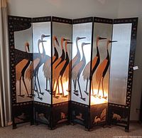 Full front view of six-panel screen showing continuous crane motif on silver-leaf background