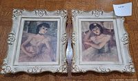 Two framed reproduction prints of ballerinas by Cherry Jeffe, set side-by-side on wood floor with ornate off-white floral patterned frames