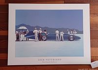 Mounted print of the Bluebird at Bonneville artwork by Jack Vettriano on a wooden background, showing full composition and text at bottom.