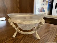 Clear textured glass bowl in decorative metal stand with detailed scroll and shell design