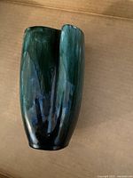 Tall green dimpled Blue Mountain Pottery vase with an elongated and open form