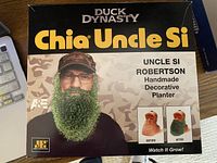 Front of the boxed Duck Dynasty Chia Uncle Si planter kit showing the product image and branding.