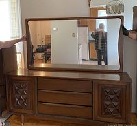 Front view of triple dresser with attached large rectangular mirror