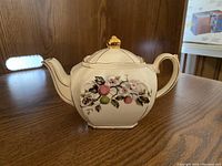 Vintage Sadler Cherry Blossoms teapot showing cherry blossom and fruit motif with gold trim, cream base color.