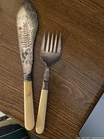 Bone handled engraved cake fork and server set with detailed design