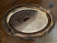 Oval tray showing intricate engraving and fluted edges