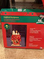 Box of Peanuts lighted sculpture with Snoopy and Woodstock on doghouse