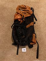 Full view of the orange and black GoLite Speed backpack showing its size and straps.