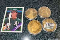 Overview showing all four silver coins in capsules and Jose Canseco card