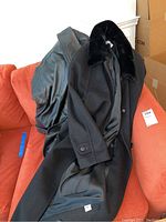 Image of two coats: black Forecaster coat with fur collar and a black leather jacket