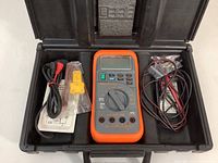Open black carrying case showing Blue-Point MT 586 Multi-Mate digital multimeter, black and red test leads, and yellow probe in plastic bag.
