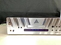 Front view of DVDMaster 8000 Pro powered on, showing control buttons, headphone jack, and LED display