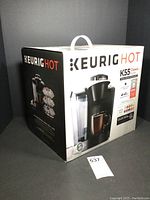 Angled front view of sealed original box for Keurig Hot K55 Classic Series coffee maker showing brand and model details.