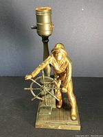Leonard Craske bronze fisherman lamp with man and ship's wheel, showing lamp socket and base