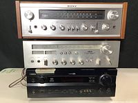 Front view of Sony, Akai and Yamaha receivers stacked