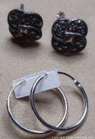 Photo showing small sterling silver hoop earrings with simple polished finish.