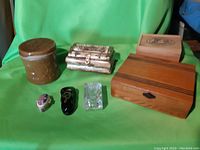 Front view of all six assorted boxes and containers against green background