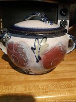 Full view of the pottery tureen with lid showing the glazed finish and color pattern.